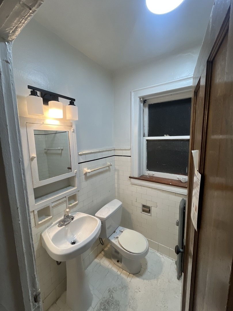 2408 East 77th Street, Unit 2 Chicago, IL 60649 - Photo 3 of 6 a bathroom with a sink toilet and mirror