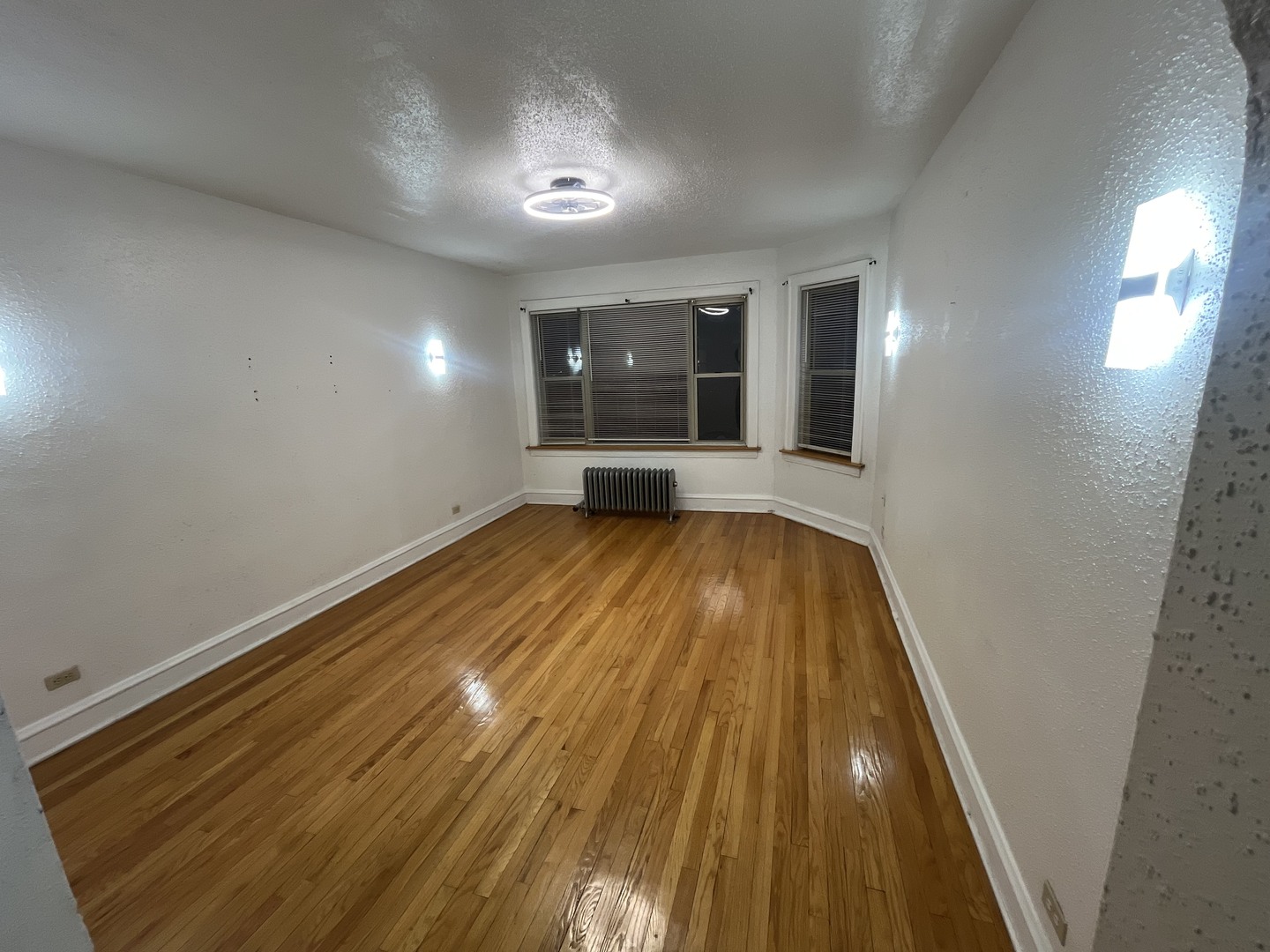 2408 East 77th Street, Unit 2 Chicago, IL 60649 - Photo 6 of 6 a view of a room with wooden floor and window