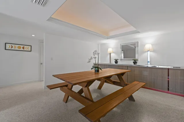 a living room with a table and chairs