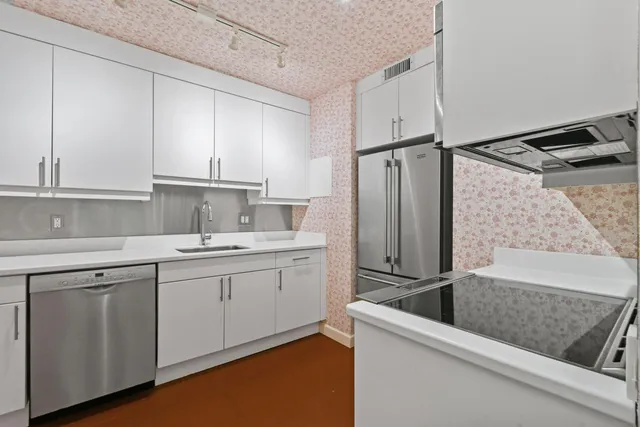 a kitchen with sink cabinets and stainless steel appliances