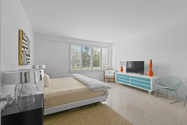 a bedroom with a bed and a couch