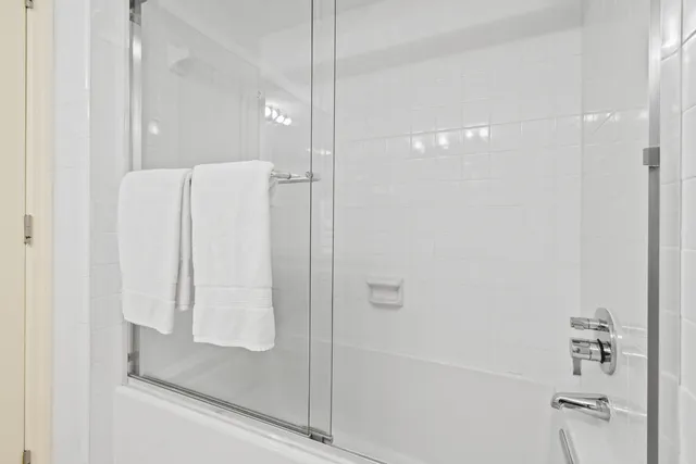 a bathroom with a toilet mirror and vanity