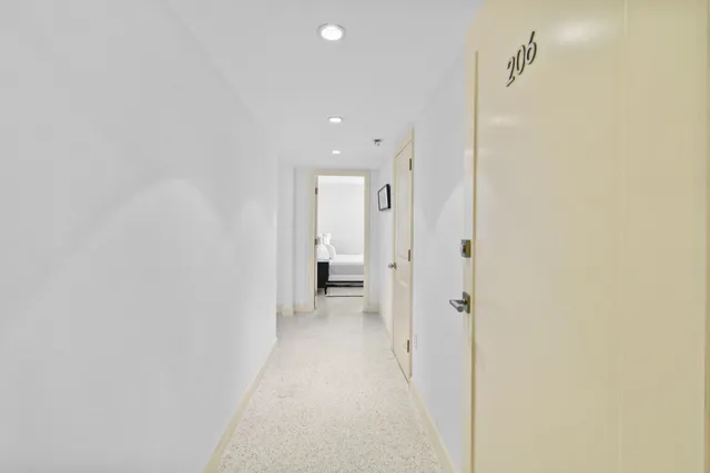 a view of a hallway with wooden shelves