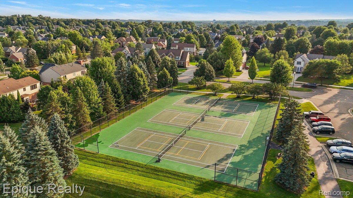 1909 Catlin Drive Rochester, MI 48306 - Photo 66 of 76 Outdoor recreational area featuring multiple tennis courts with green surfaces and white line markings