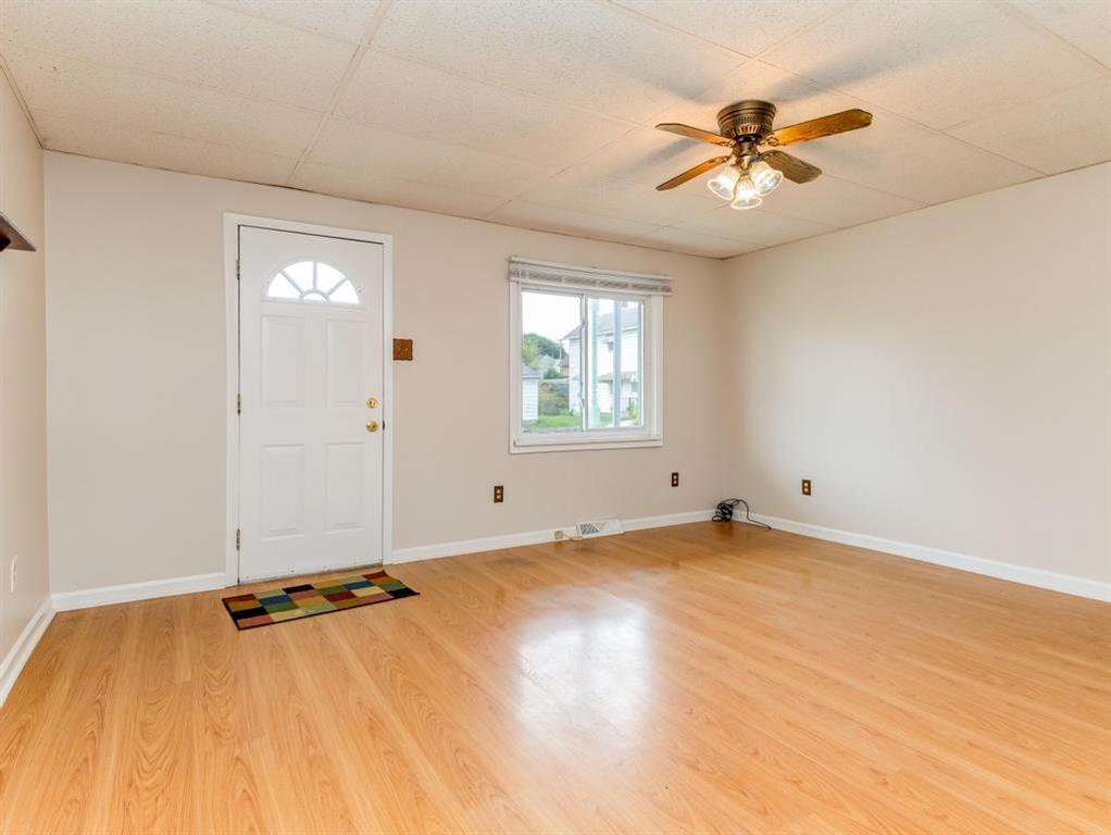 448 Park Street Rochester, PA 15074 - Photo 12 of 29 an empty room with a window and a ceiling fan