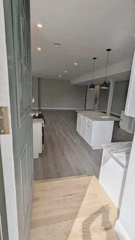 a view of a living room and wooden floor