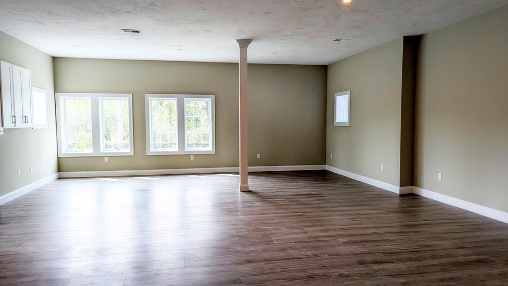 31 Cross Street Boylston, MA 01505 - Photo 22 of 42 an empty room with wooden floor and windows