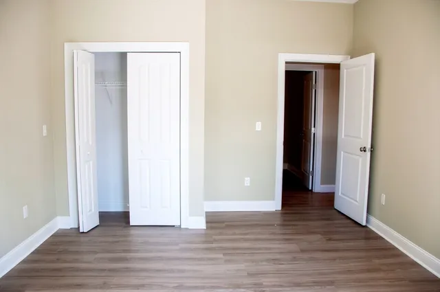 a view of wooden floor and closet in a room