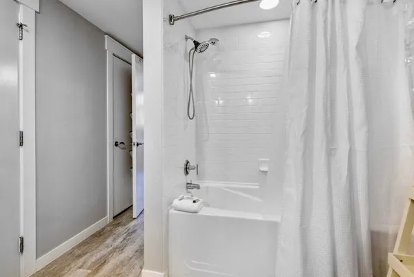 a bathroom with a bathtub and shower