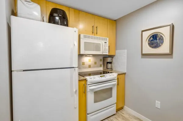 a white refrigerator freezer sitting inside of a kitchen