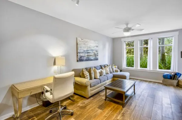 a living room with furniture and wooden floor