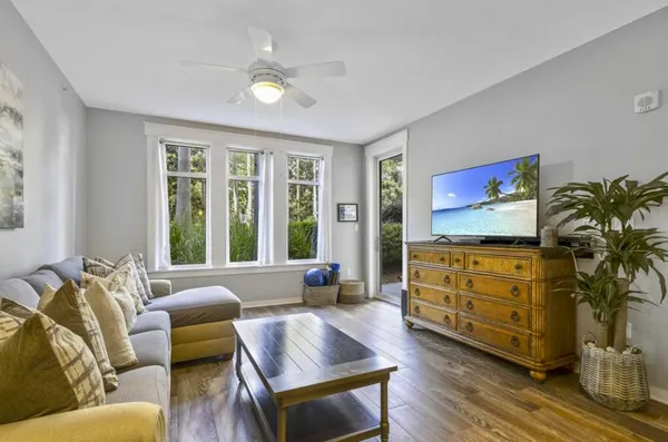 a living room with furniture cabinets and a window