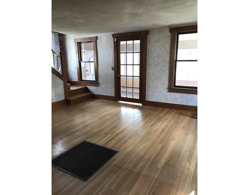 1241 Allen Street Springfield, MA 01118 - Photo 4 of 11 a view of an empty room with wooden floor and a window