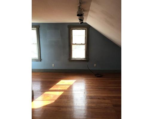 1241 Allen Street Springfield, MA 01118 - Photo 5 of 11 a view of an empty room with wooden floor and a window