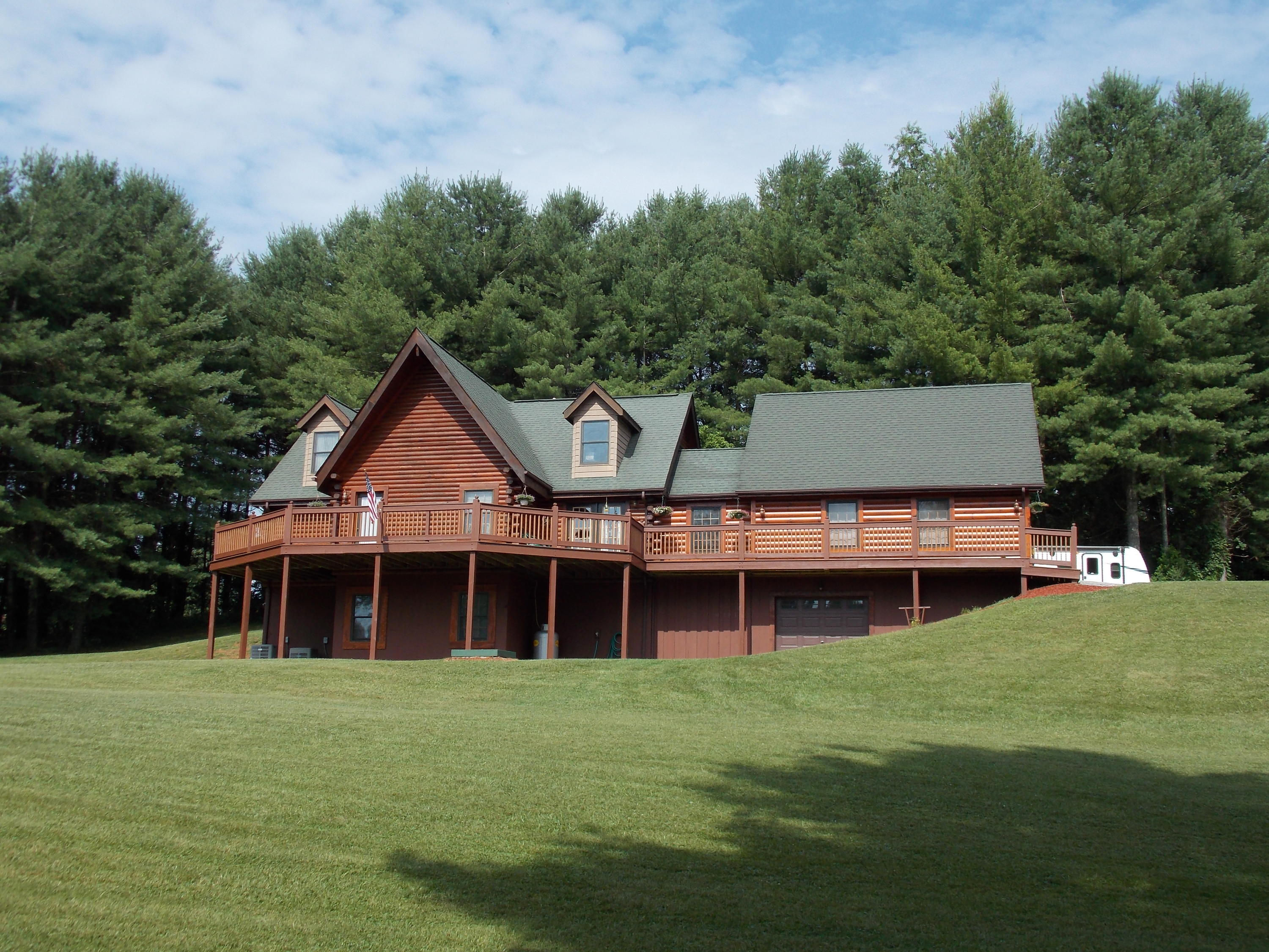124 Ridgeview Road Northwest Floyd, VA 24091 - Photo 2 of 67 a front view of a house with a garden and yard