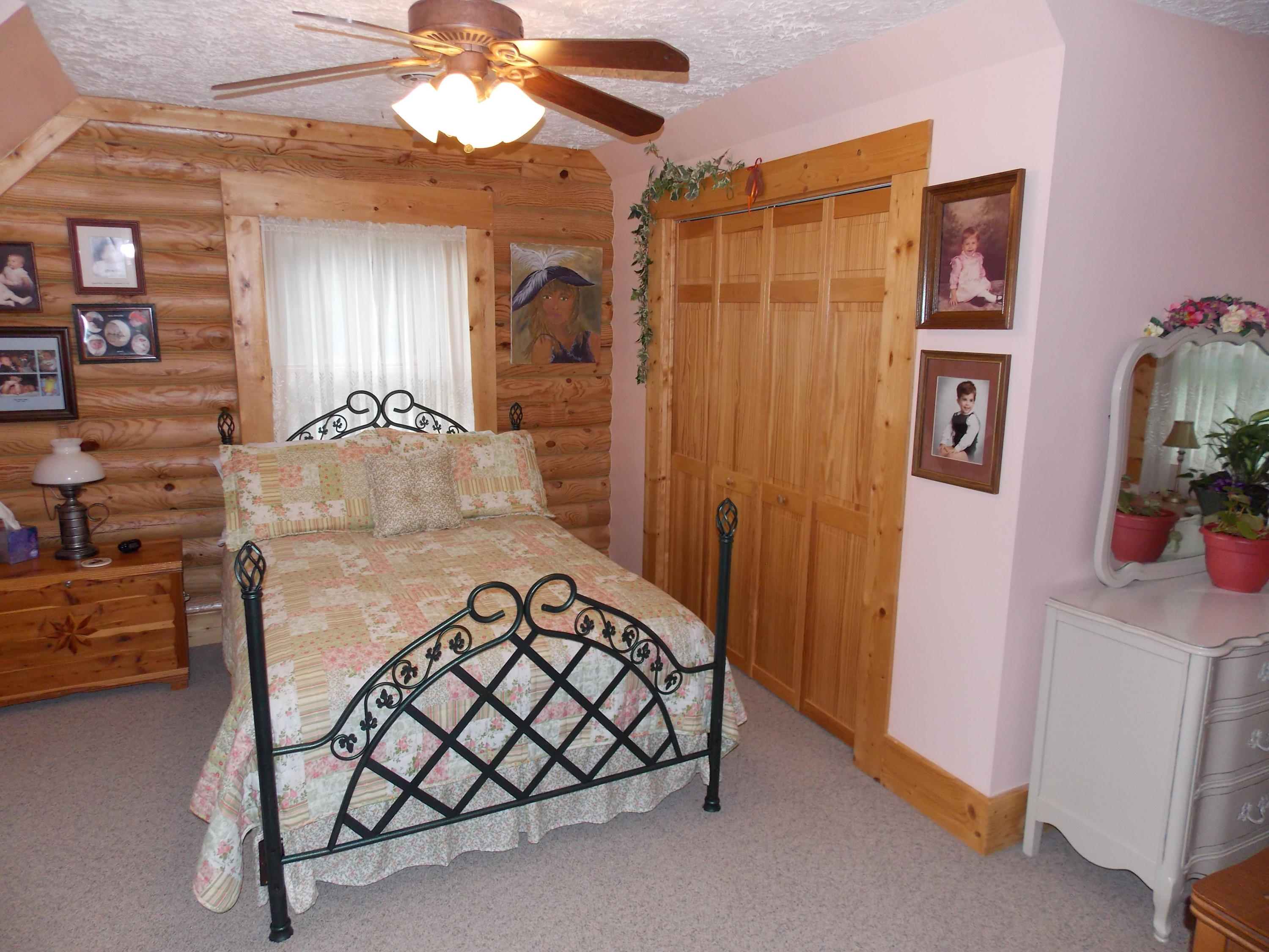 124 Ridgeview Road Northwest Floyd, VA 24091 - Photo 42 of 67 a bedroom with a bed and a chandelier