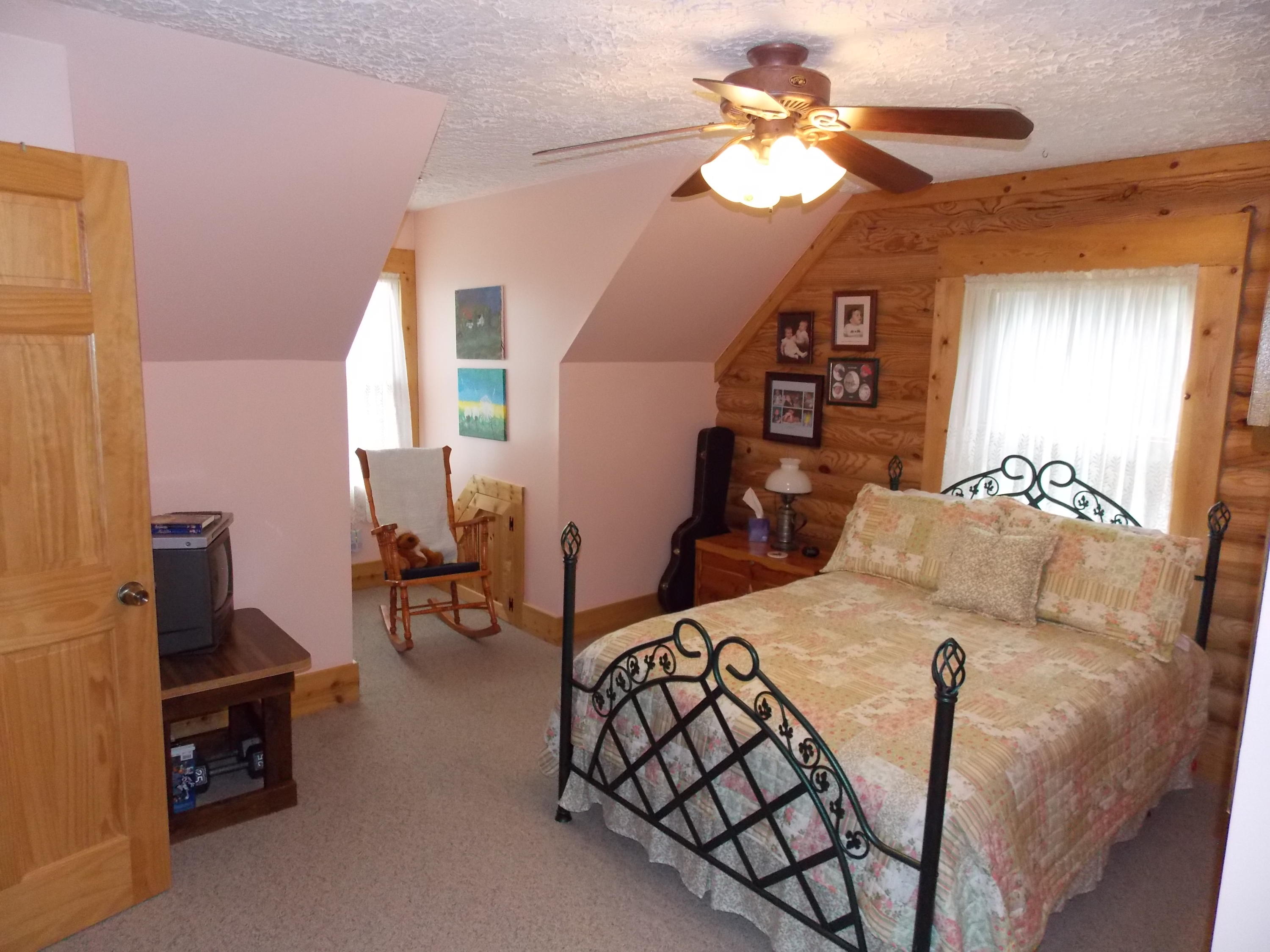 124 Ridgeview Road Northwest Floyd, VA 24091 - Photo 43 of 67 a bedroom with furniture and a chandelier