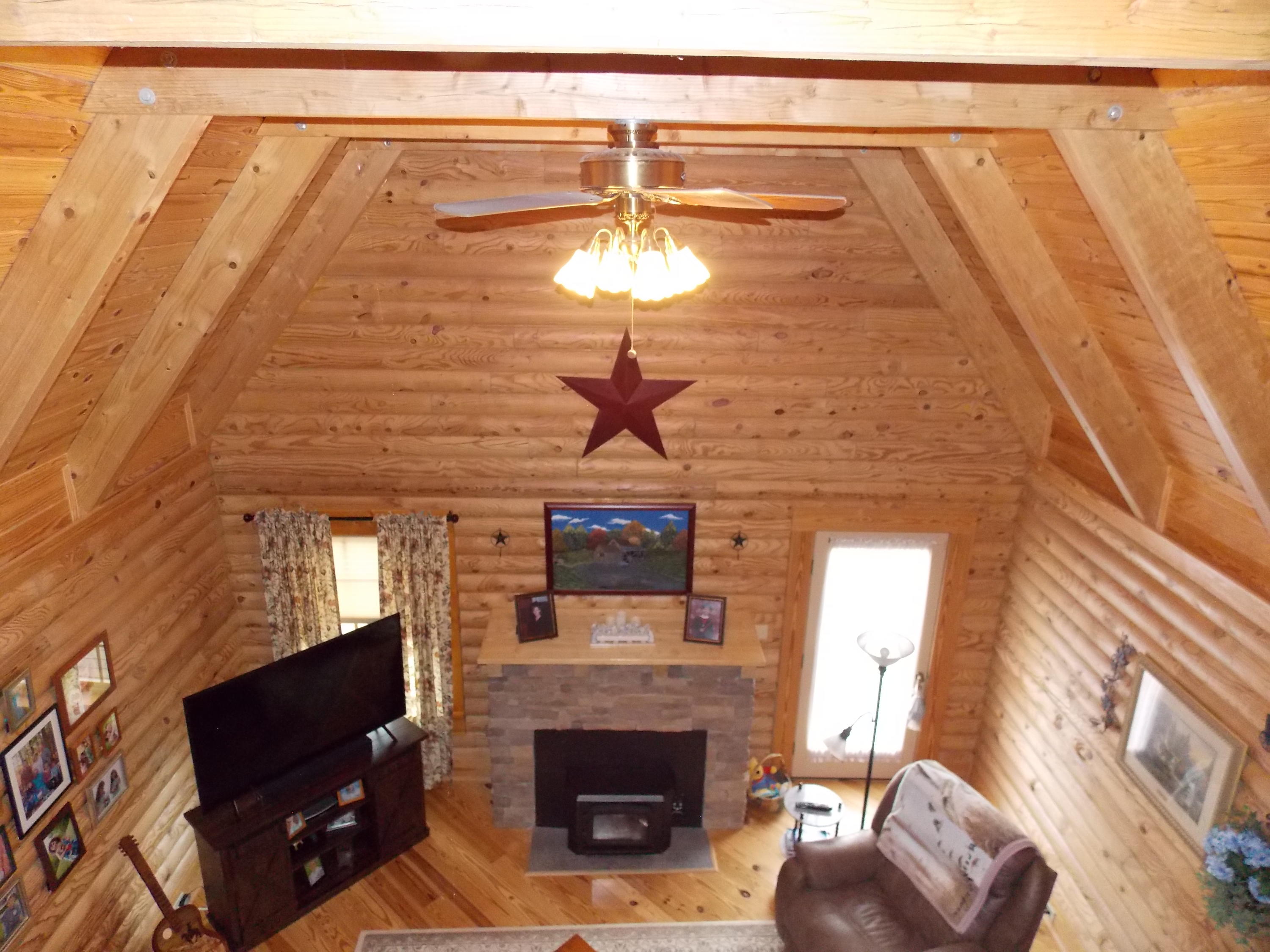 124 Ridgeview Road Northwest Floyd, VA 24091 - Photo 48 of 67 a living room with a fireplace furniture a rug and a window