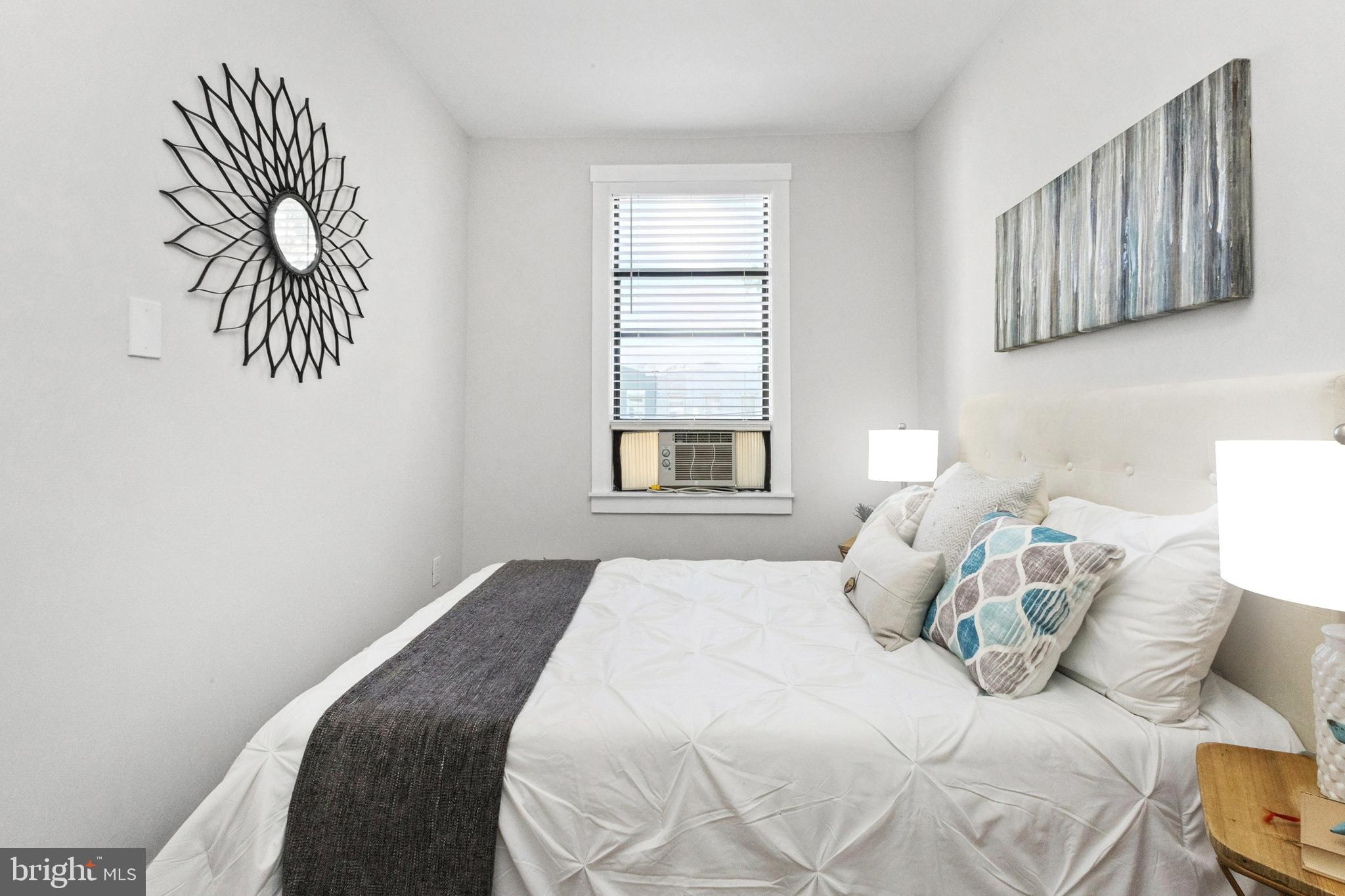 7 18th Street Southeast, Unit 208 Washington, DC 20003 - Photo 20 of 32 a bedroom with a bed and a painting on the wall