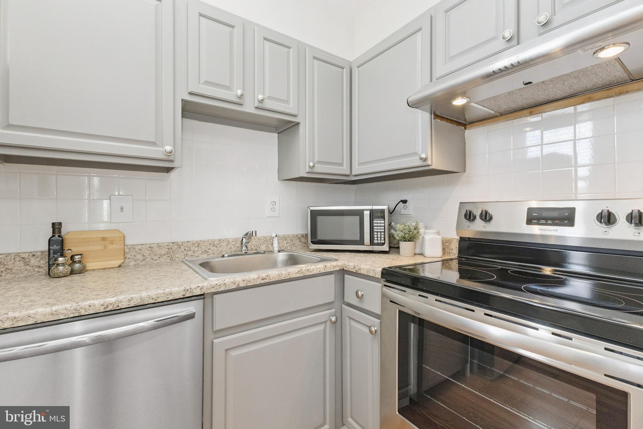 7 18th Street Southeast, Unit 208 Washington, DC 20003 - Photo 9 of 32 a kitchen with stainless steel appliances granite countertop a sink and a stove