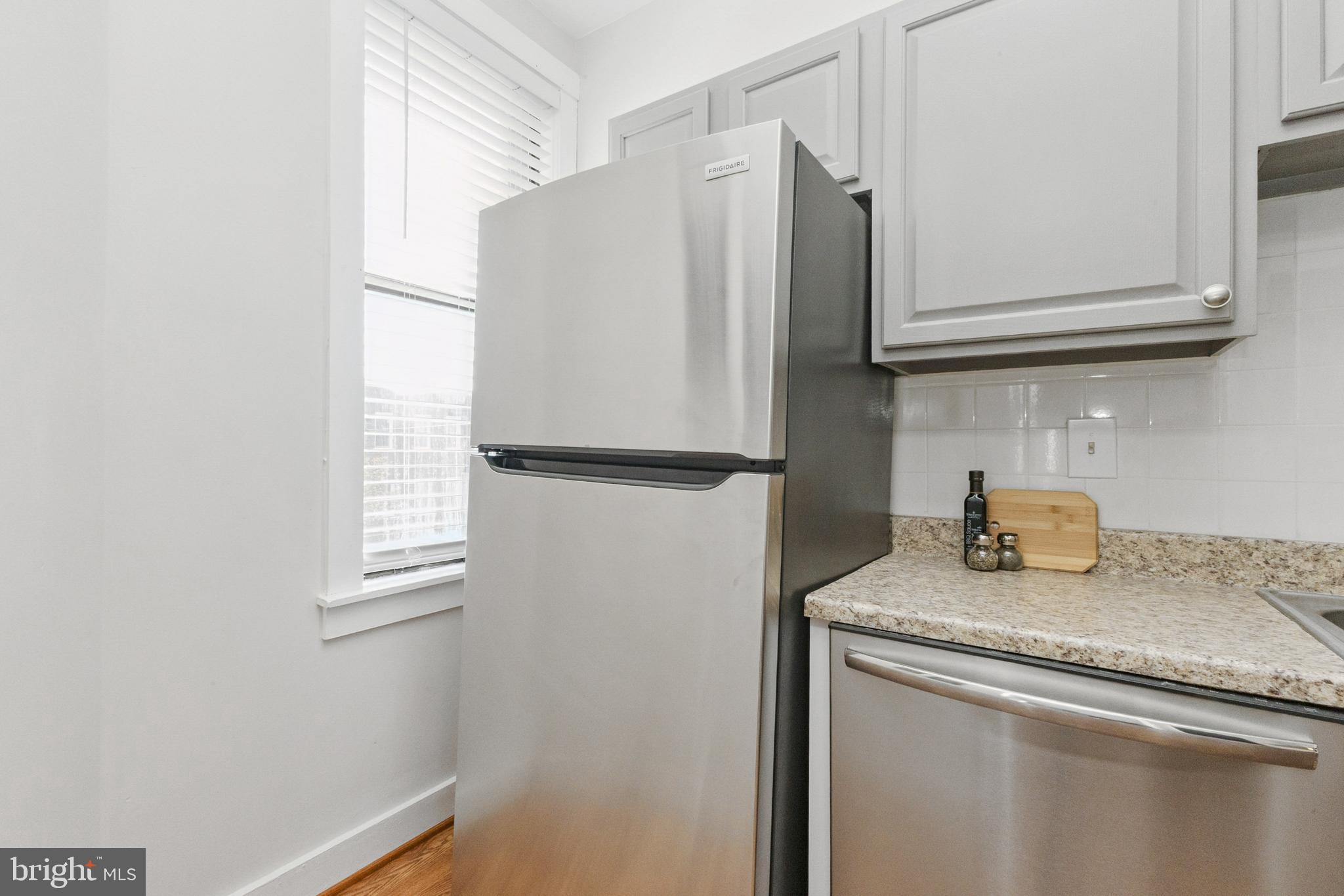 7 18th Street Southeast, Unit 208 Washington, DC 20003 - Photo 10 of 32 a kitchen with granite countertop cabinets stainless steel appliances and a counter space