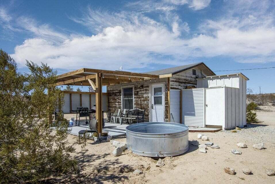 63637 Gemini Road Joshua Tree, CA 92252 - Photo 16 of 22 a view of a house with wooden floor and a potted plant