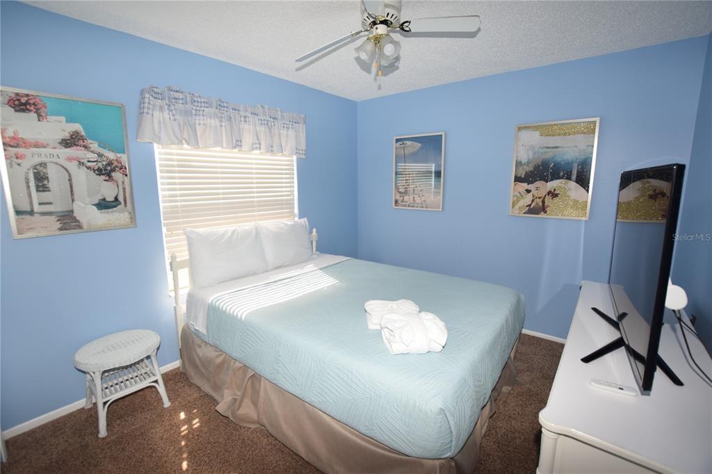 7748 Indian Ridge Trail South Kissimmee, FL 34747 - Photo 35 of 37 a white table sitting in a bedroom next to a window