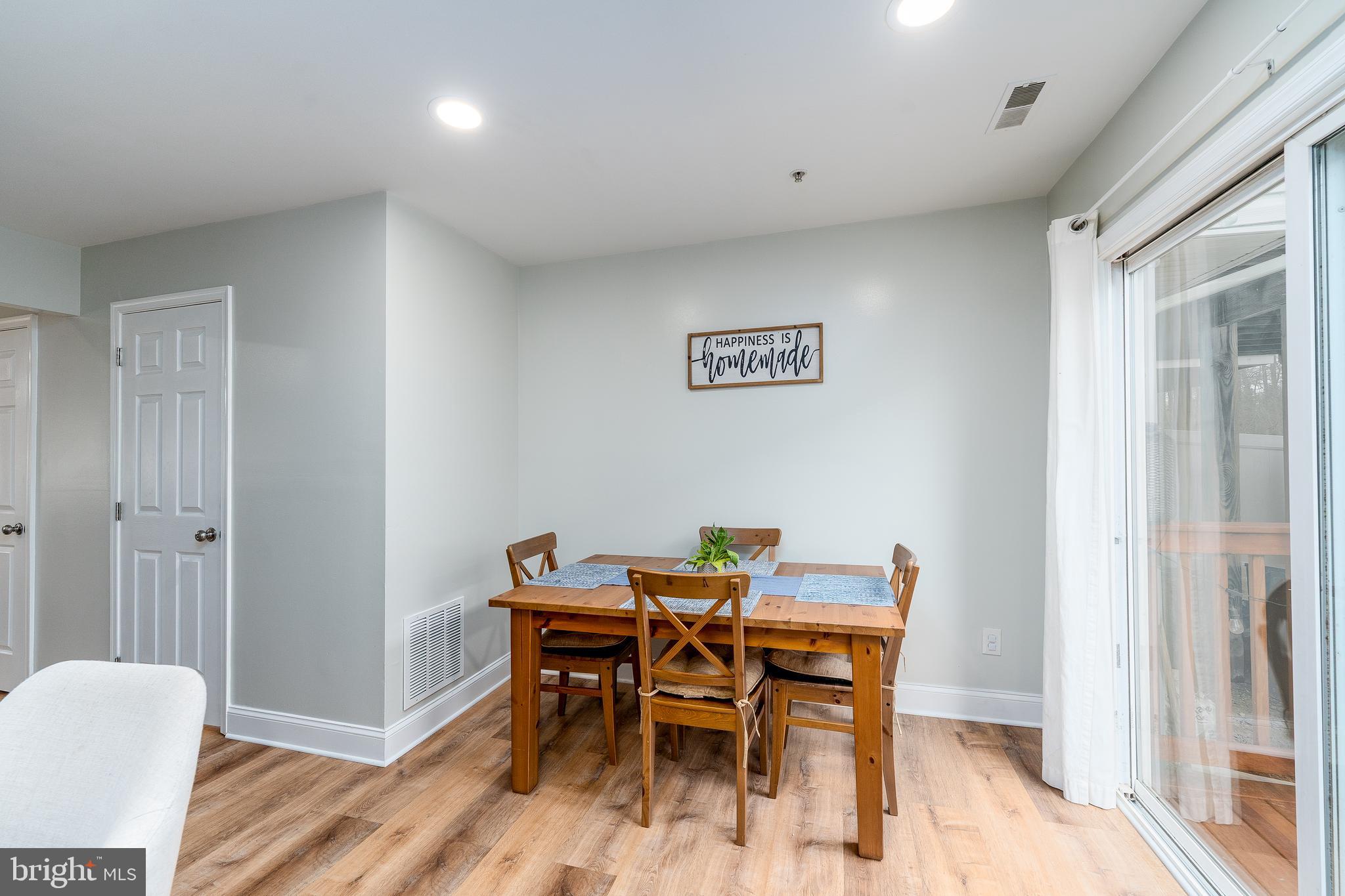 688 Luthardt Road Baltimore, MD 21220 - Photo 11 of 32 a dining room with furniture and wooden floor