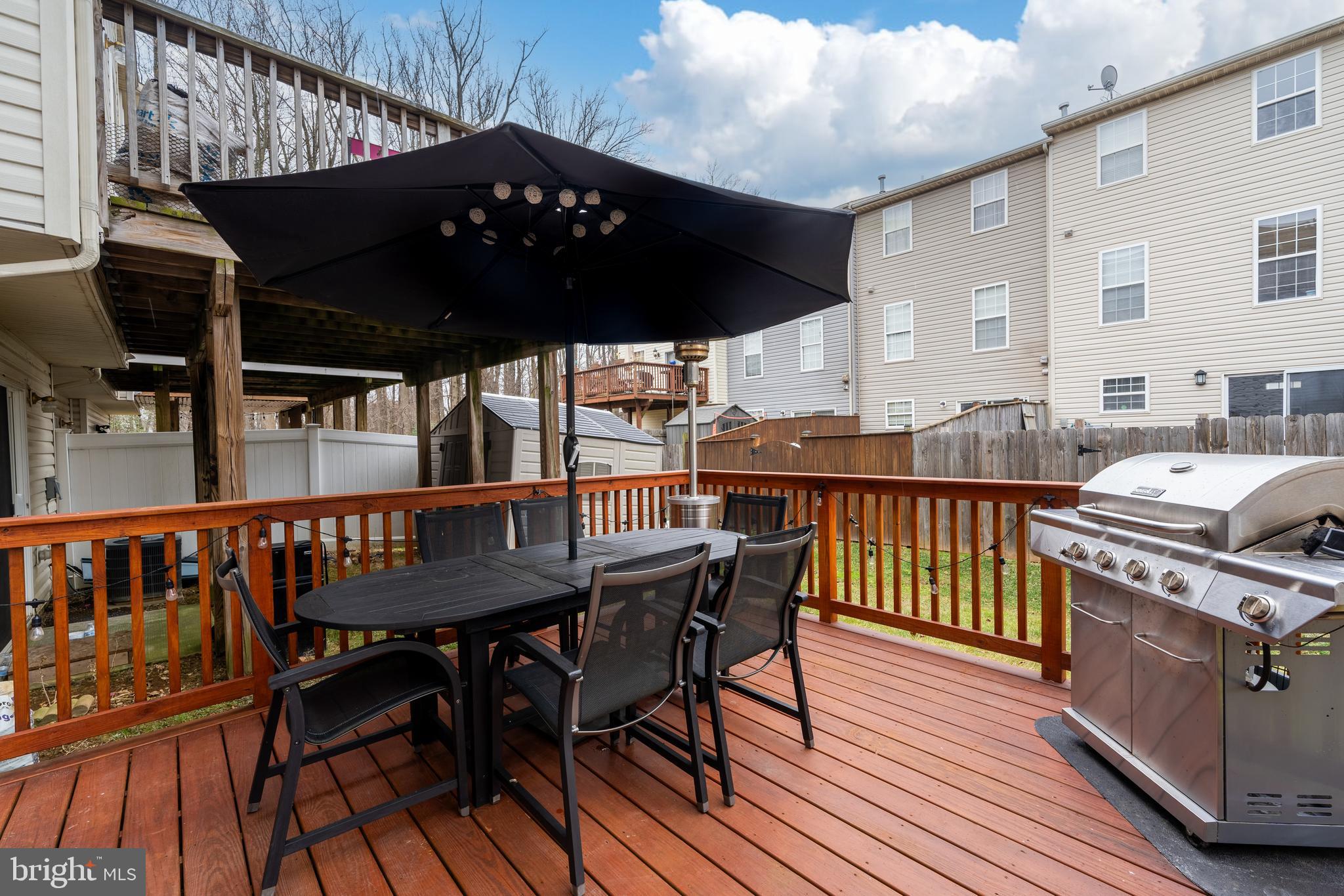688 Luthardt Road Baltimore, MD 21220 - Photo 14 of 32 a view of a roof deck with table and chairs with wooden floor