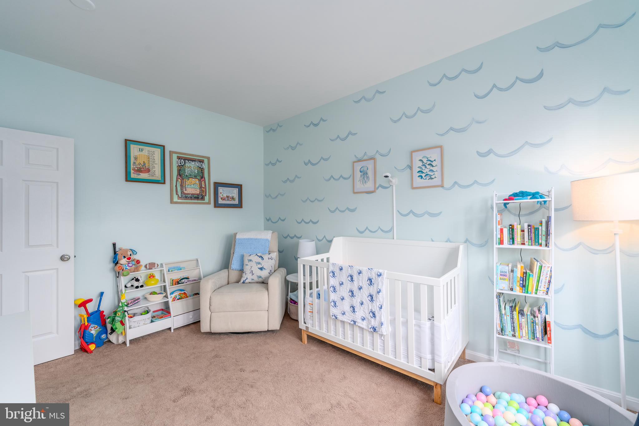 688 Luthardt Road Baltimore, MD 21220 - Photo 19 of 32 a bedroom with baby bed toys and paintings on the wall