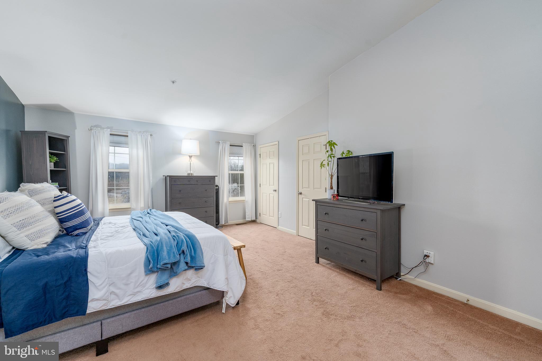 688 Luthardt Road Baltimore, MD 21220 - Photo 22 of 32 a spacious bedroom with a bed and a flat screen tv