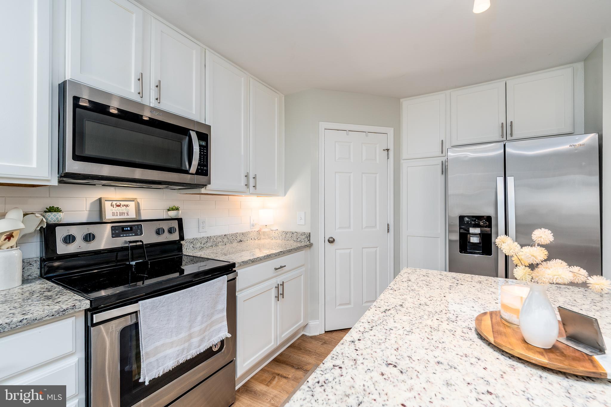 688 Luthardt Road Baltimore, MD 21220 - Photo 7 of 32 a kitchen with a stove and a white cabinets