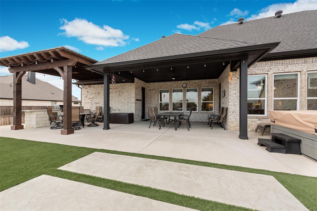 4041 Richard Road Midlothian, TX 76065 - Photo 12 of 36 a view of a patio with table and chairs potted plants and a large tree