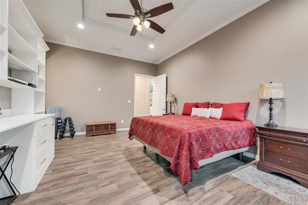 4041 Richard Road Midlothian, TX 76065 - Photo 16 of 36 a bedroom with a large bed and a chandelier