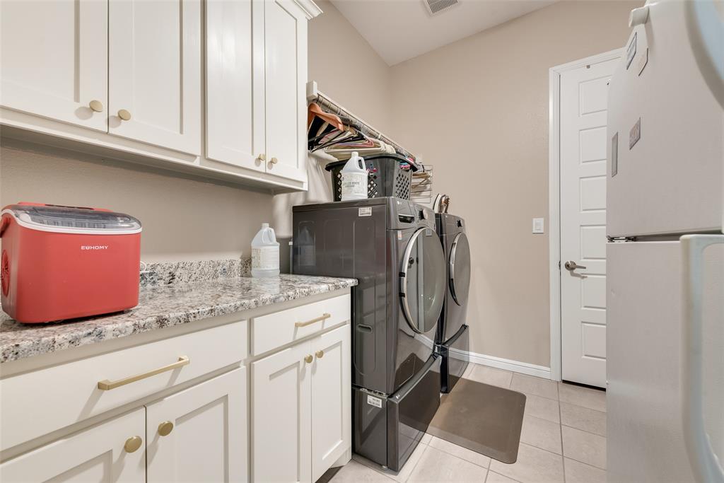 4041 Richard Road Midlothian, TX 76065 - Photo 18 of 36 a utility room with granite countertop a sink a washer and dryer