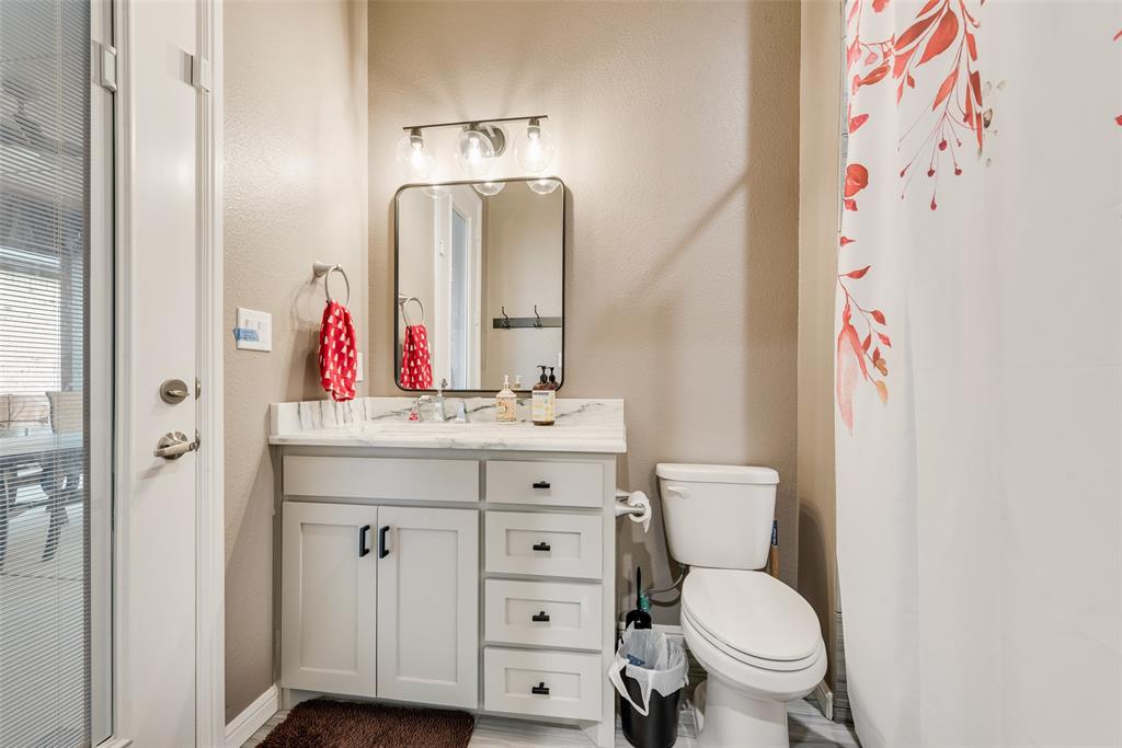 4041 Richard Road Midlothian, TX 76065 - Photo 20 of 36 a bathroom with a toilet sink and mirror