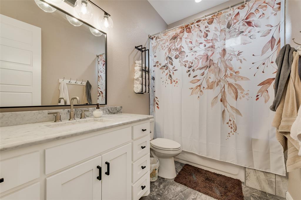 4041 Richard Road Midlothian, TX 76065 - Photo 24 of 36 a bathroom with a granite countertop sink toilet and shower