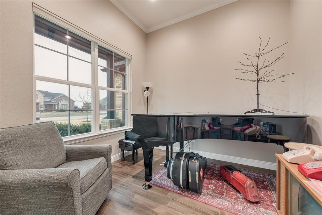 4041 Richard Road Midlothian, TX 76065 - Photo 26 of 36 a living room with furniture a flat screen tv and a floor to ceiling window