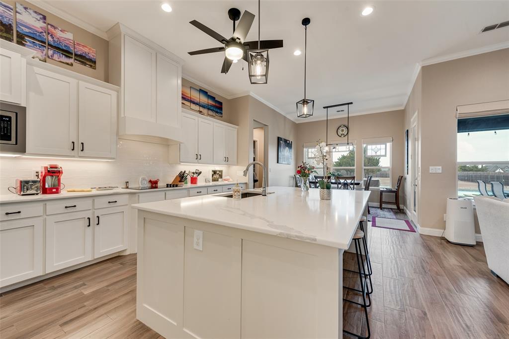 4041 Richard Road Midlothian, TX 76065 - Photo 28 of 36 a kitchen with stainless steel appliances kitchen island granite countertop a stove a sink and a refrigerator