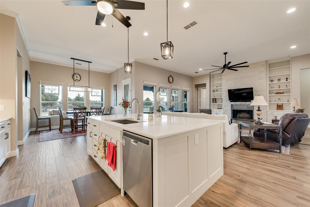 4041 Richard Road Midlothian, TX 76065 - Photo 29 of 36 a large kitchen with stainless steel appliances kitchen island granite countertop a large center island and a wooden floors
