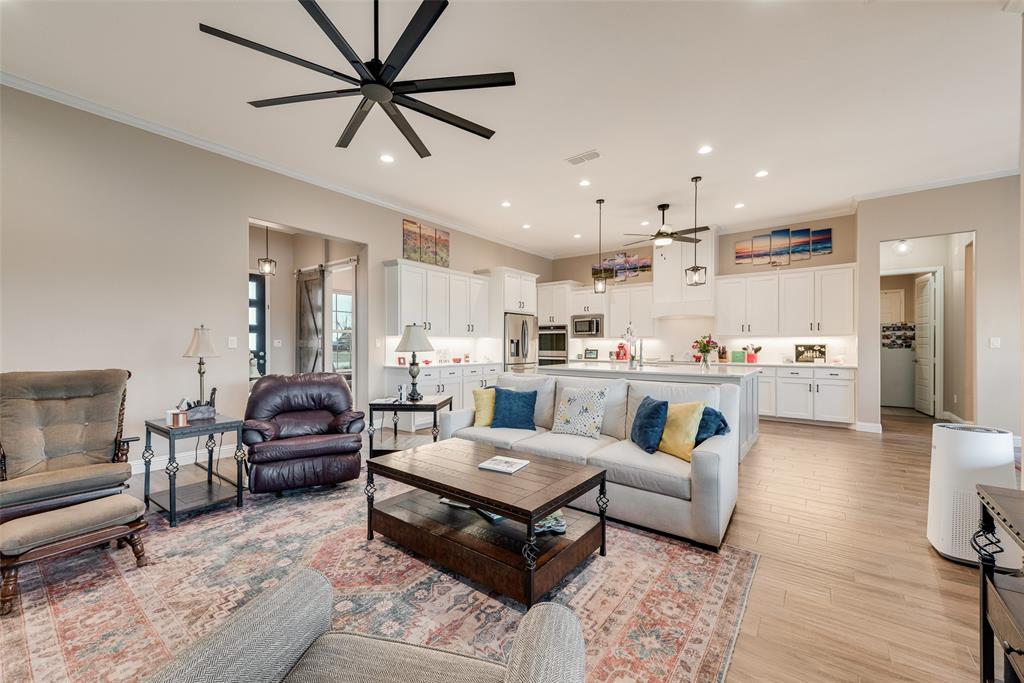 4041 Richard Road Midlothian, TX 76065 - Photo 32 of 36 a living room with furniture kitchen view and a chandelier