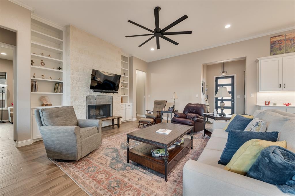 4041 Richard Road Midlothian, TX 76065 - Photo 33 of 36 a living room with furniture a fireplace and a flat screen tv
