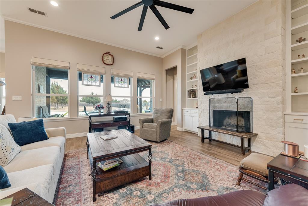 4041 Richard Road Midlothian, TX 76065 - Photo 34 of 36 a living room with furniture a flat screen tv and a fireplace