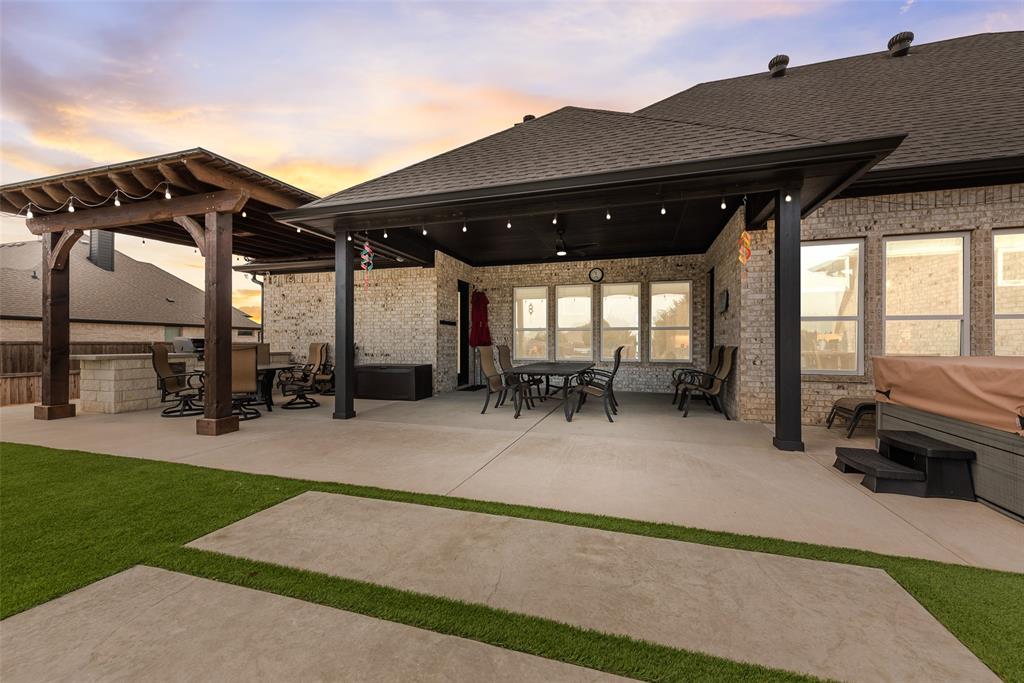 4041 Richard Road Midlothian, TX 76065 - Photo 5 of 36 a view of a patio with table and chairs under an umbrella