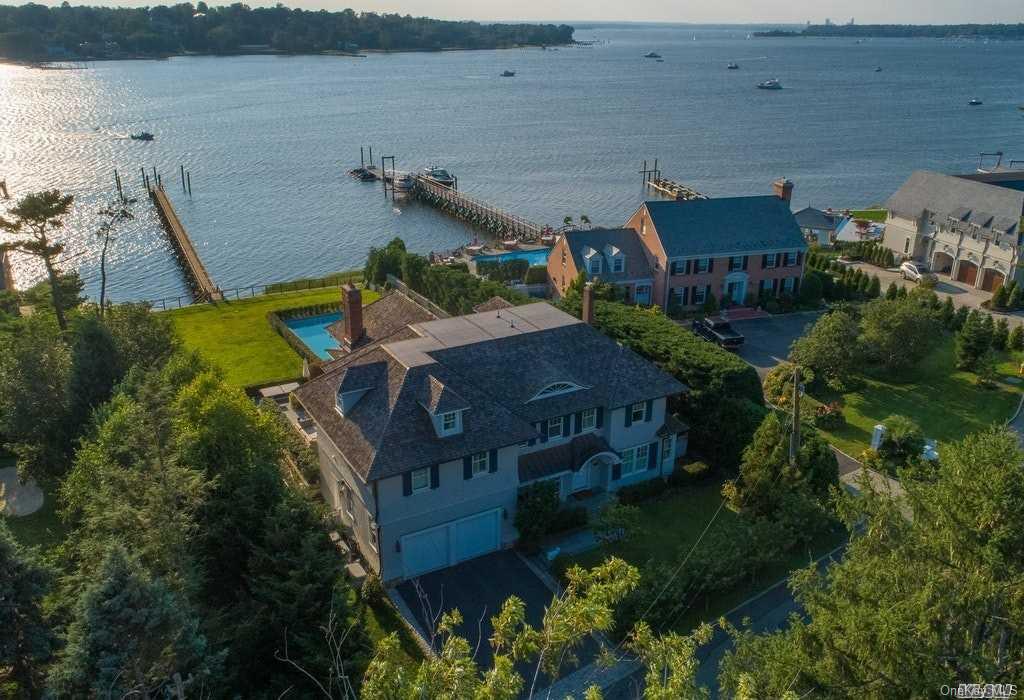 an aerial view of a house with outdoor space and lake view
