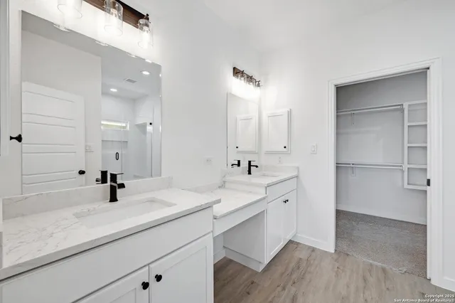 a bathroom with a glass shower door and a bathtub