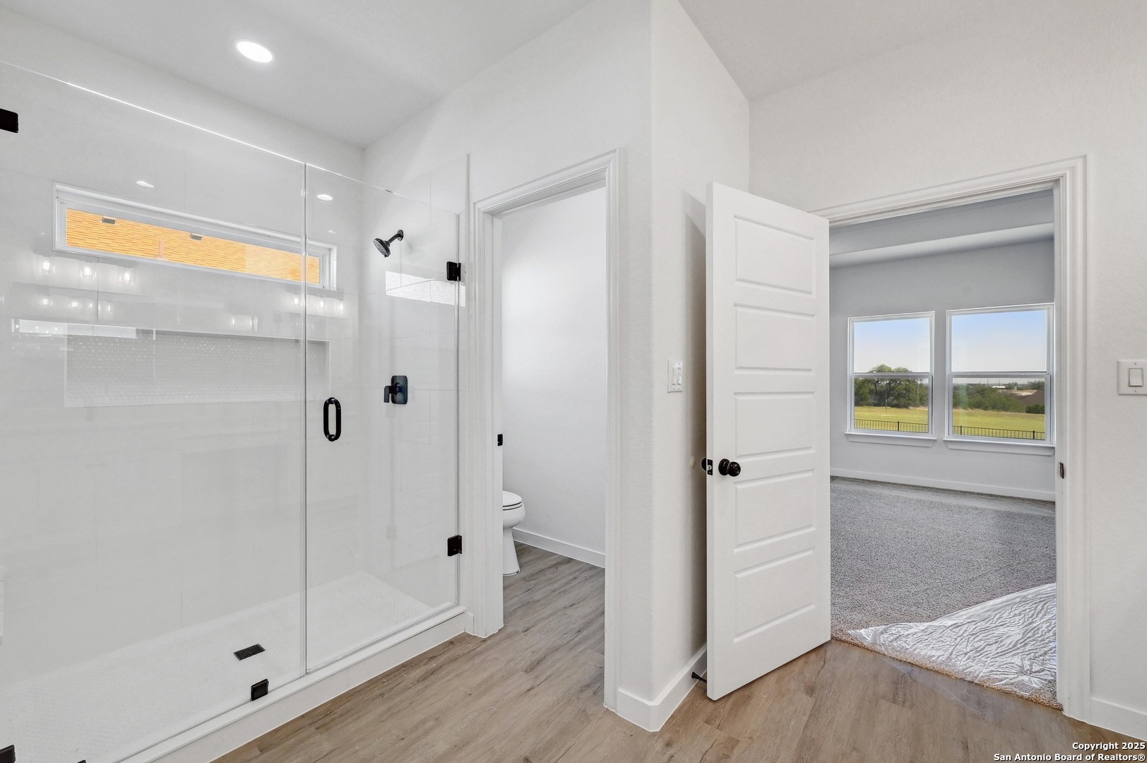 236 Peter Kleid Loop Blanco, TX 78606 - Photo 15 of 21 a bathroom with a glass shower door and a bathtub