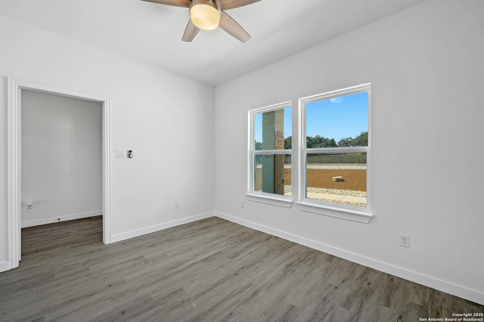 236 Peter Kleid Loop Blanco, TX 78606 - Photo 16 of 21 an empty room with wooden floor and windows