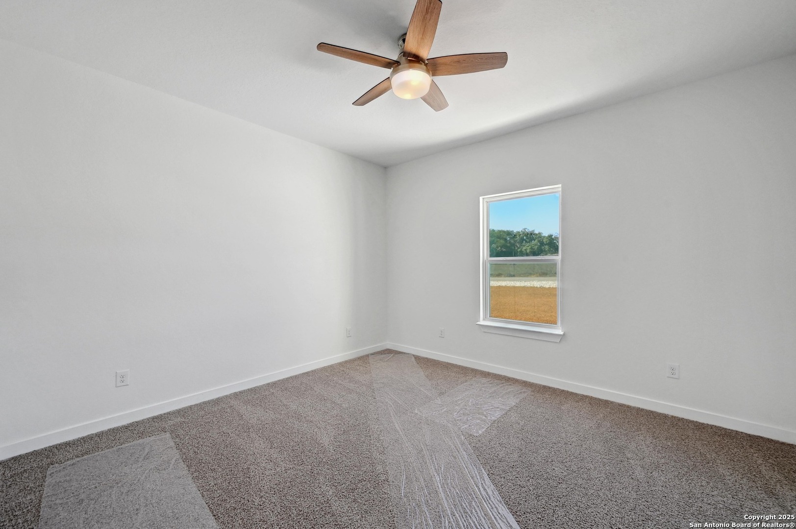 236 Peter Kleid Loop Blanco, TX 78606 - Photo 17 of 21 an empty room with a window and a fan