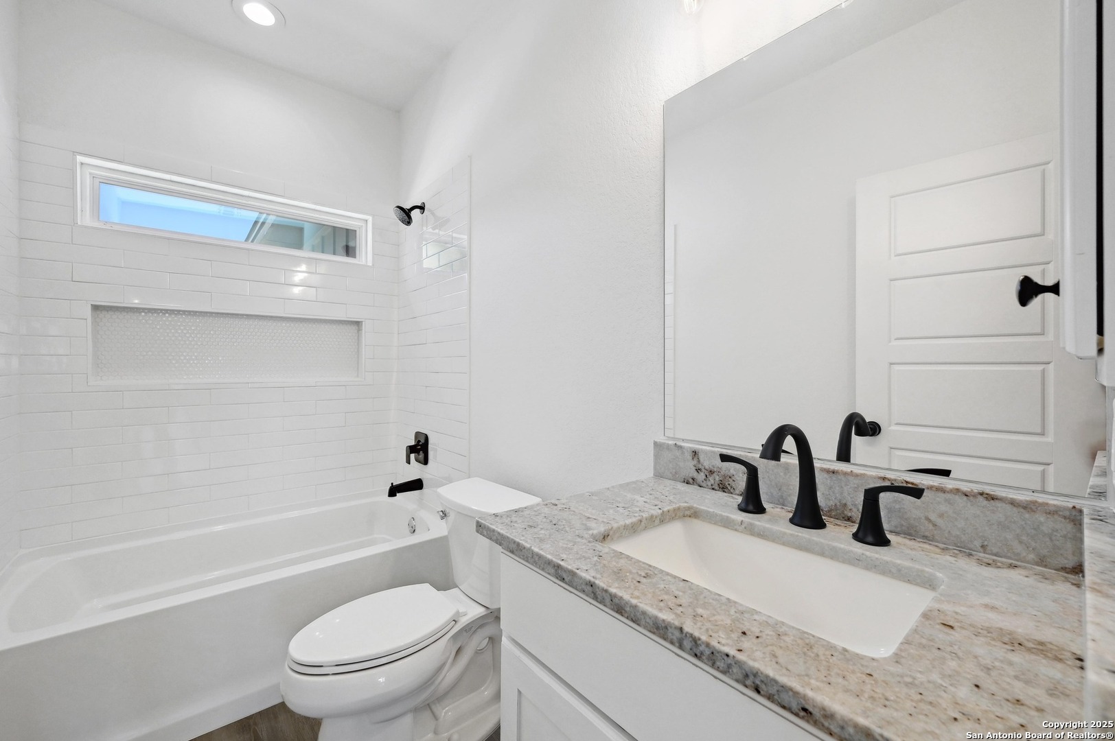 236 Peter Kleid Loop Blanco, TX 78606 - Photo 18 of 21 a bathroom with a granite countertop toilet a sink and a bathtub